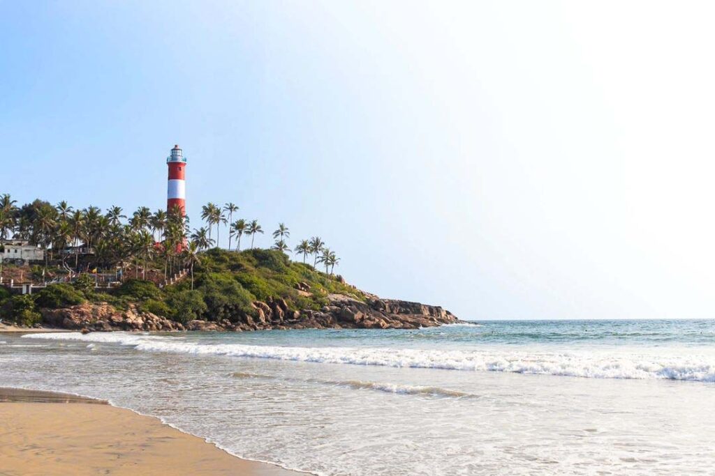 Lighthouse at Kovalam Beach, a must-visit among the top beaches in Kerala, surrounded by golden sands