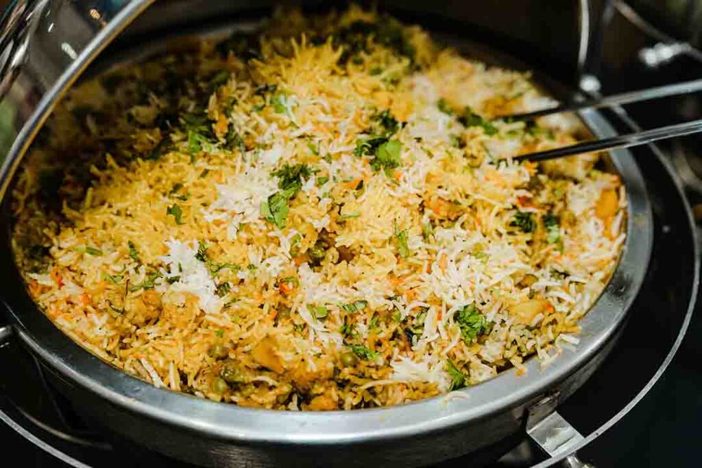 A flavorful Kozhikode-style Malabar biriyani served with aromatic spices, tender meat, and fragrant rice