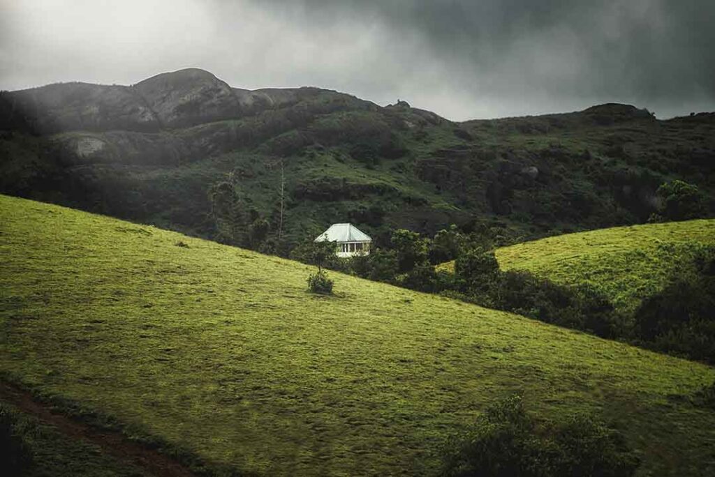Rolling green meadows and a tranquil lake in the serene Vagamon hill station of Kerala